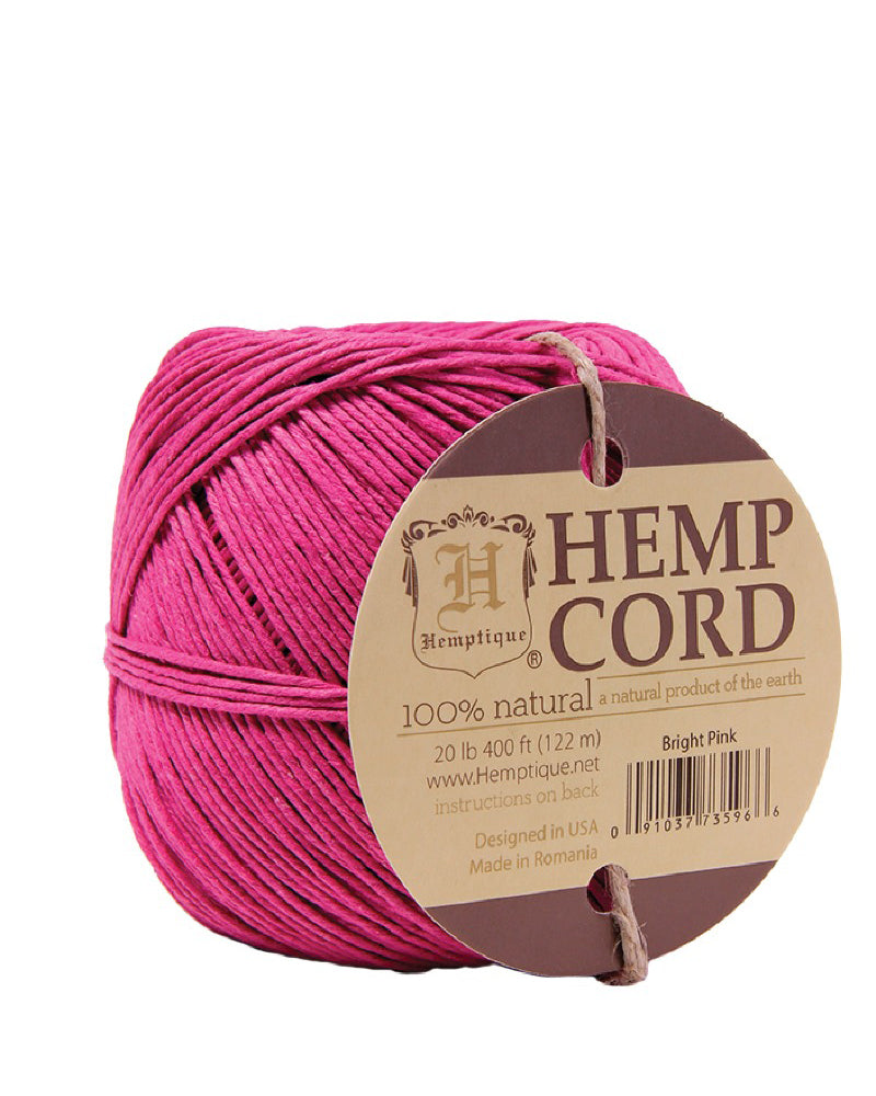 A ball of bright pink hemp cord with a label indicating it is 100% natural hemp cord designed in the USA by Hemptique.